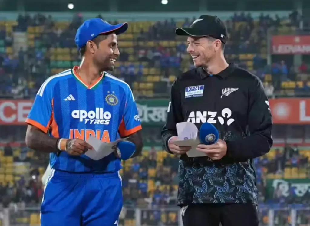 Suryakumar Yadav and Mitchell Santner at the toss for India vs New Zealand T20 match in Vizag 2026, featuring the evening stadium lights and team jerseys.