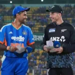 Suryakumar Yadav and Mitchell Santner at the toss for India vs New Zealand T20 match in Vizag 2026, featuring the evening stadium lights and team jerseys.