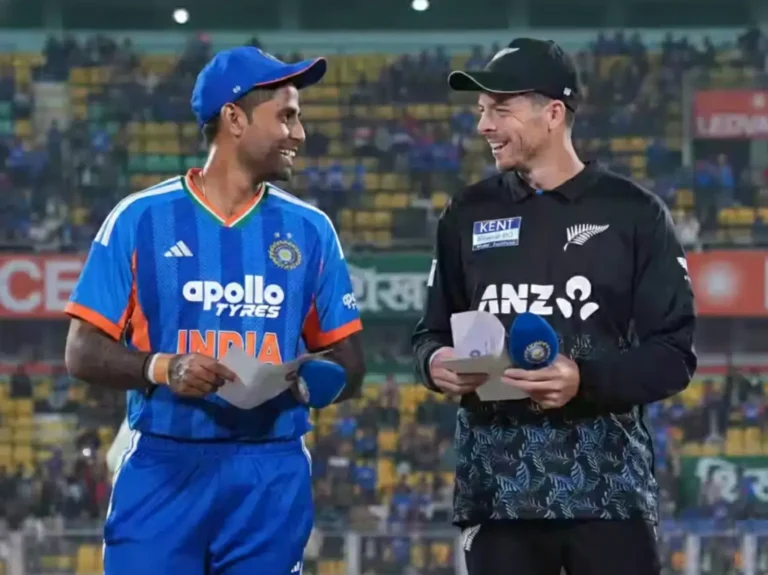 Suryakumar Yadav and Mitchell Santner at the toss for India vs New Zealand T20 match in Vizag 2026, featuring the evening stadium lights and team jerseys.